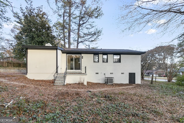 3215 Pennignton Cir, Atlanta, GA 30354 - back of property featuring brick siding, cooling unit, crawl space, entry steps, and a chimney