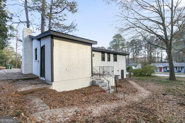 3215 Pennignton Cir, Atlanta, GA 30354 - view of side of home with a chimney