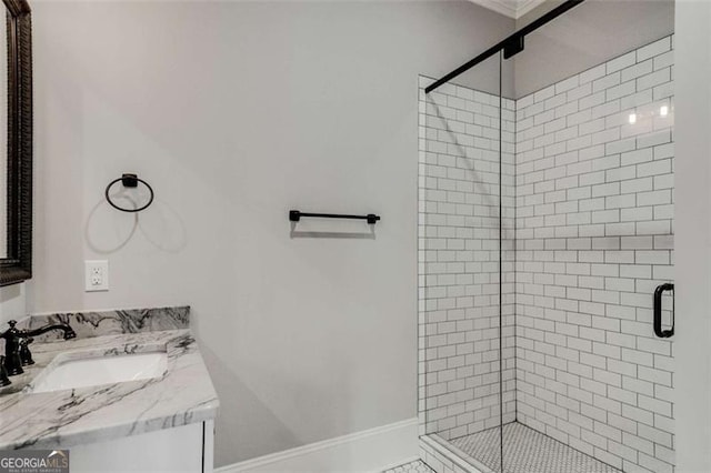 bathroom with a shower stall, vanity, and baseboards