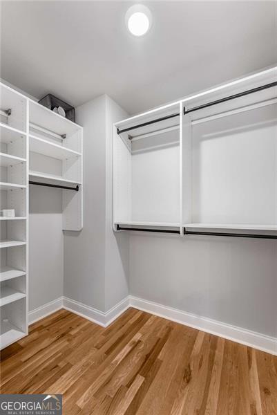 spacious closet with wood finished floors