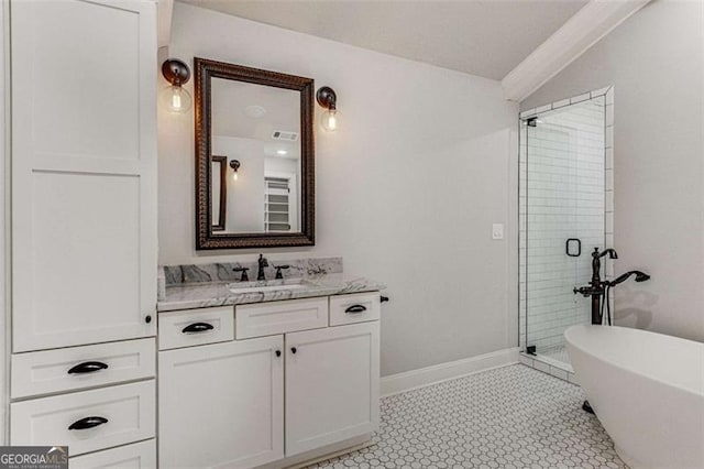 bathroom with a stall shower, vanity, baseboards, and a soaking tub