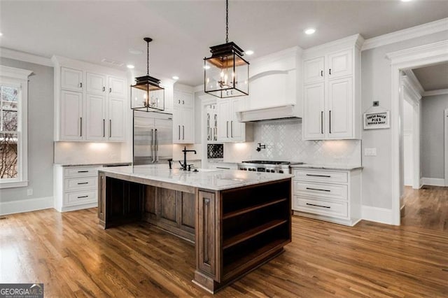 kitchen featuring stainless steel built in refrigerator, baseboards, white cabinetry, recessed lighting, and crown molding