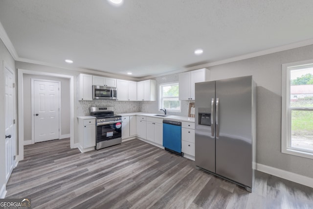 11 Cloverhurst Dr, Toccoa, GA 30577 - kitchen with appliances with stainless steel finishes, a sink, light countertops, crown molding, and decorative backsplash