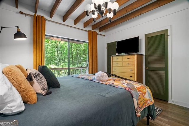 bedroom featuring a chandelier, beamed ceiling, and wood finished floors