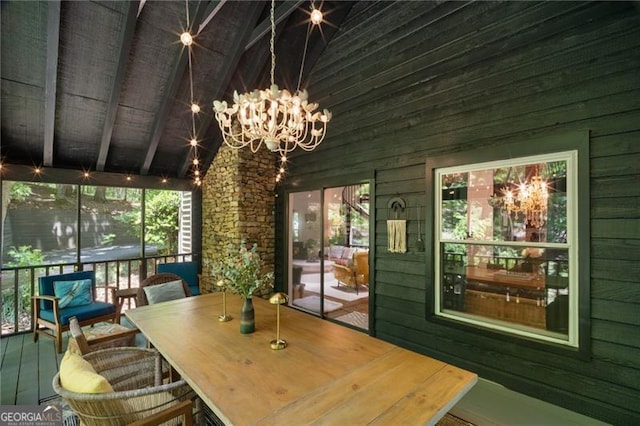sunroom featuring a chandelier