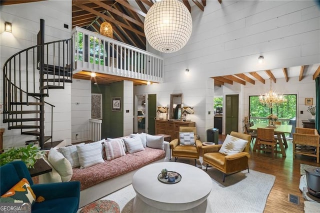 living room with a chandelier, high vaulted ceiling, wood finished floors, stairs, and beamed ceiling