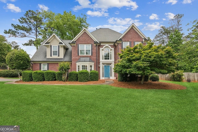 840 Yosemite Dr, Suwanee, GA 30024 - colonial house featuring brick siding and a shingled roof