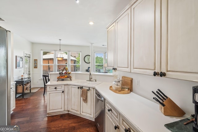840 Yosemite Dr, Suwanee, GA 30024 - kitchen with stainless steel appliances, a sink, a peninsula, dark wood-style flooring, and light countertops