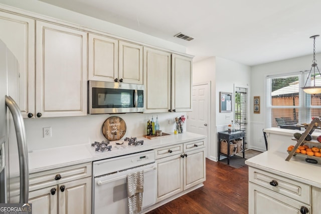 840 Yosemite Dr, Suwanee, GA 30024 - kitchen with white appliances, cream cabinetry, dark wood-style floors, and light countertops