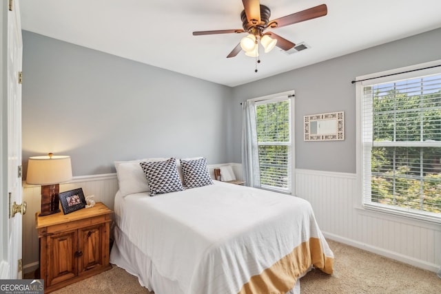 840 Yosemite Dr, Suwanee, GA 30024 - bedroom featuring a wainscoted wall, light colored carpet, and ceiling fan