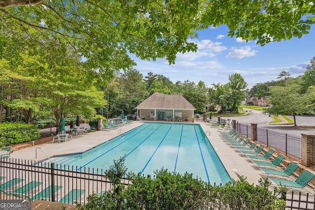 840 Yosemite Dr, Suwanee, GA 30024 - community pool featuring fence, a patio area, and view of scattered trees