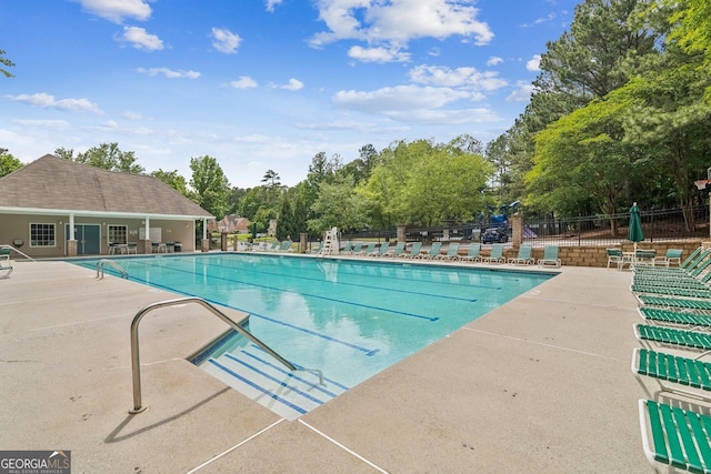 840 Yosemite Dr, Suwanee, GA 30024 - community pool featuring fence, a patio area, and view of wooded area