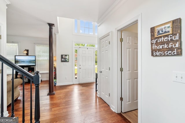 840 Yosemite Dr, Suwanee, GA 30024 - foyer with crown molding, healthy amount of natural light, hardwood / wood-style floors, and decorative columns