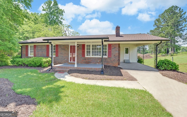 ranch-style home with concrete driveway, covered porch, a front yard, a chimney, and an attached carport