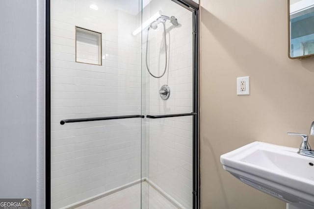 full bath featuring a sink and a stall shower