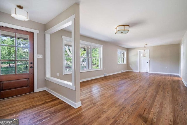 foyer featuring wood finished floors and baseboards