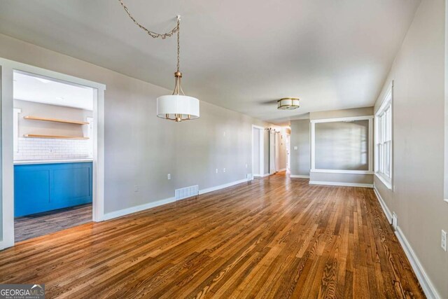 empty room with wood finished floors and baseboards