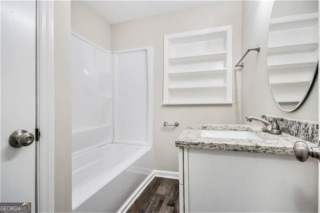 3436 Dodson, Atlanta, GA 30344 - bathroom with baseboards, wood finished floors, vanity, and shower / bathtub combination