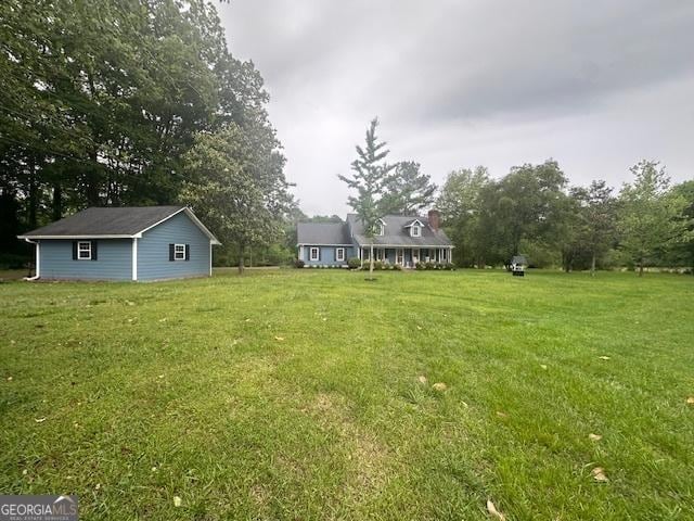view of green lawn with view of scattered trees