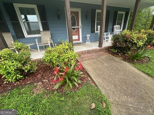 view of exterior entry with a porch