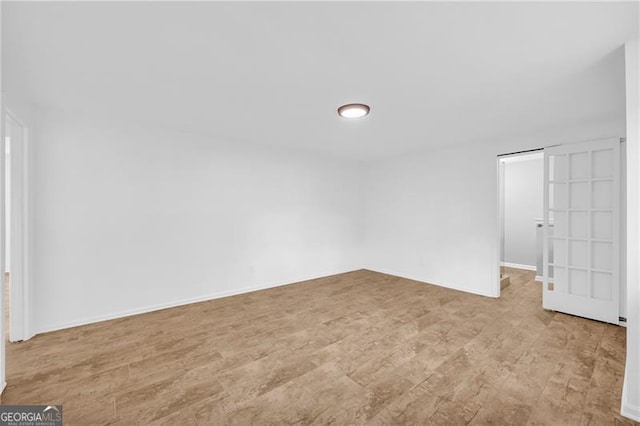 unfurnished bedroom with wood finished floors and baseboards
