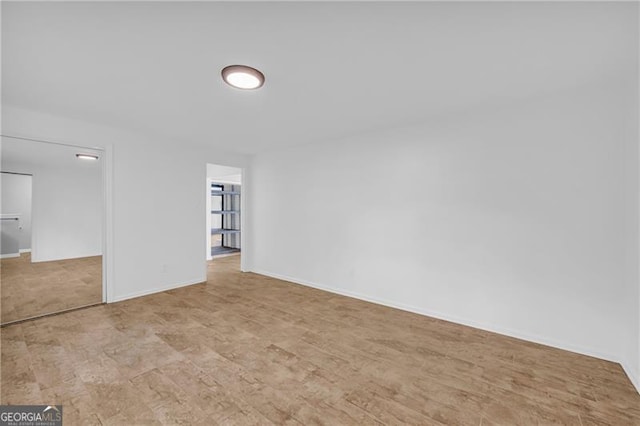 unfurnished room featuring baseboards