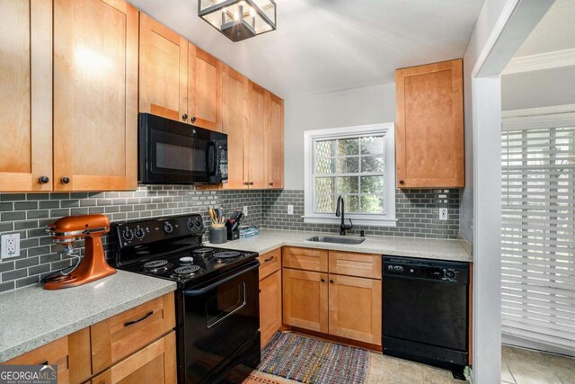kitchen with black appliances, a sink, decorative backsplash, and light tile patterned flooring