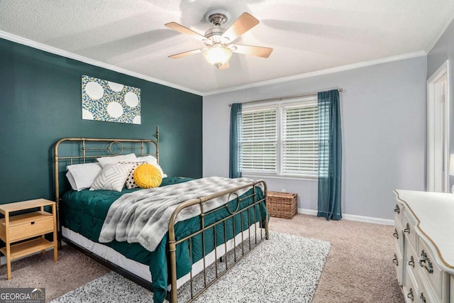 carpeted bedroom featuring ornamental molding, ceiling fan, and baseboards