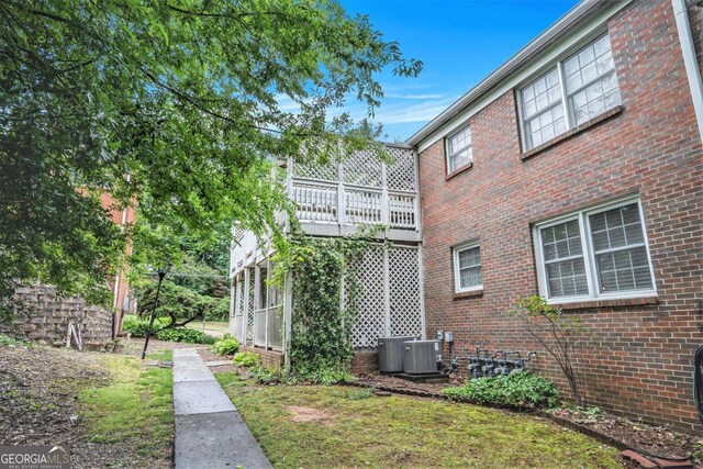 view of property exterior featuring brick siding and central AC unit