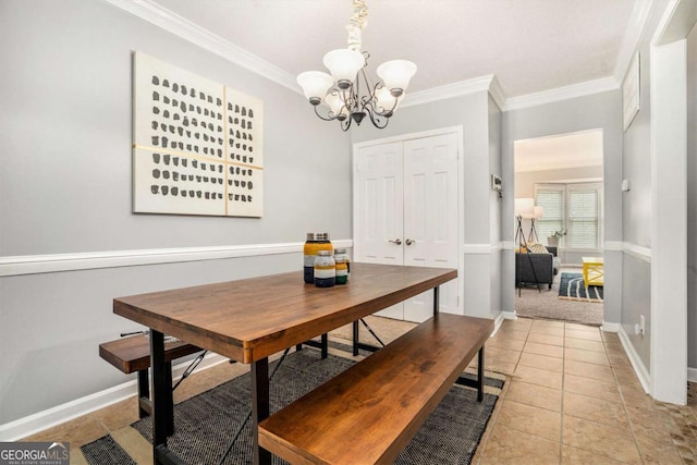 dining area featuring a chandelier, ornamental molding, and baseboards