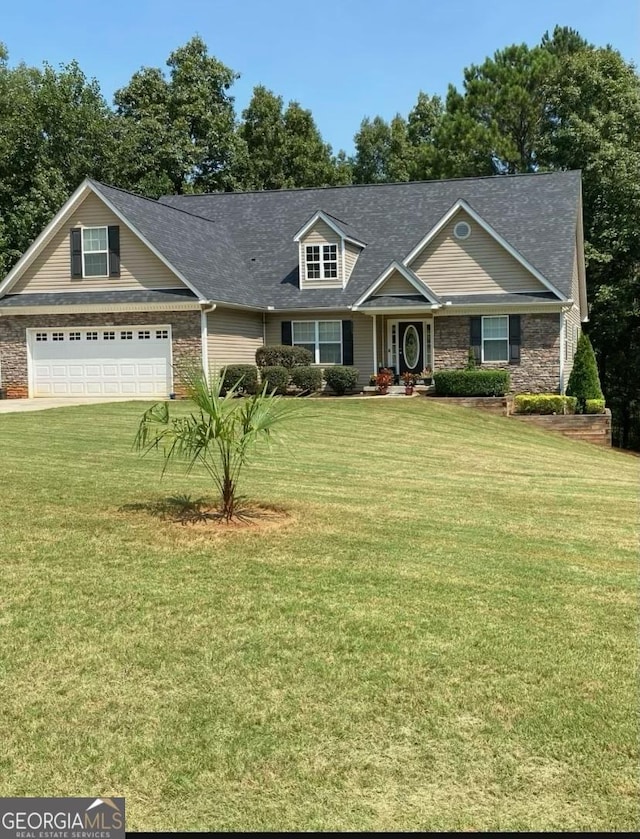 view of front of home with a front yard and a garage