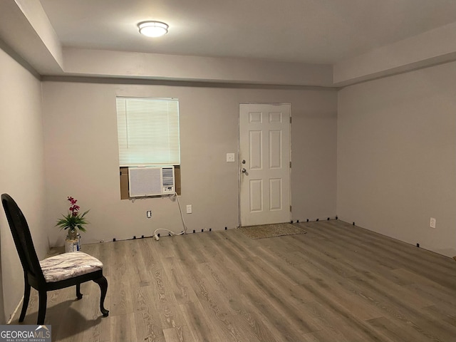 living area featuring wood finished floors and cooling unit