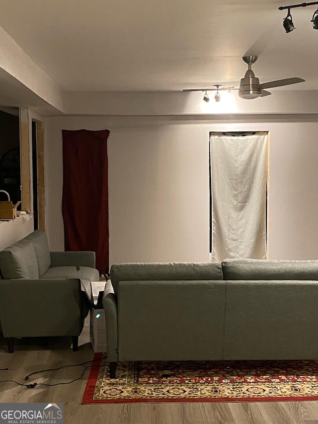 living room with rail lighting, a ceiling fan, and wood finished floors