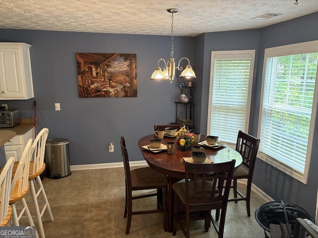 565 Miles Ct, Locust Grove, GA 30248 - dining space featuring a chandelier and baseboards
