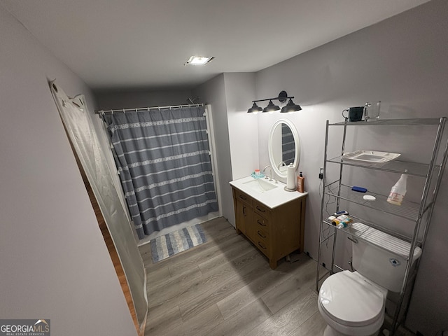 565 Miles Ct, Locust Grove, GA 30248 - full bathroom with wood finished floors, vanity, toilet, and curtained shower
