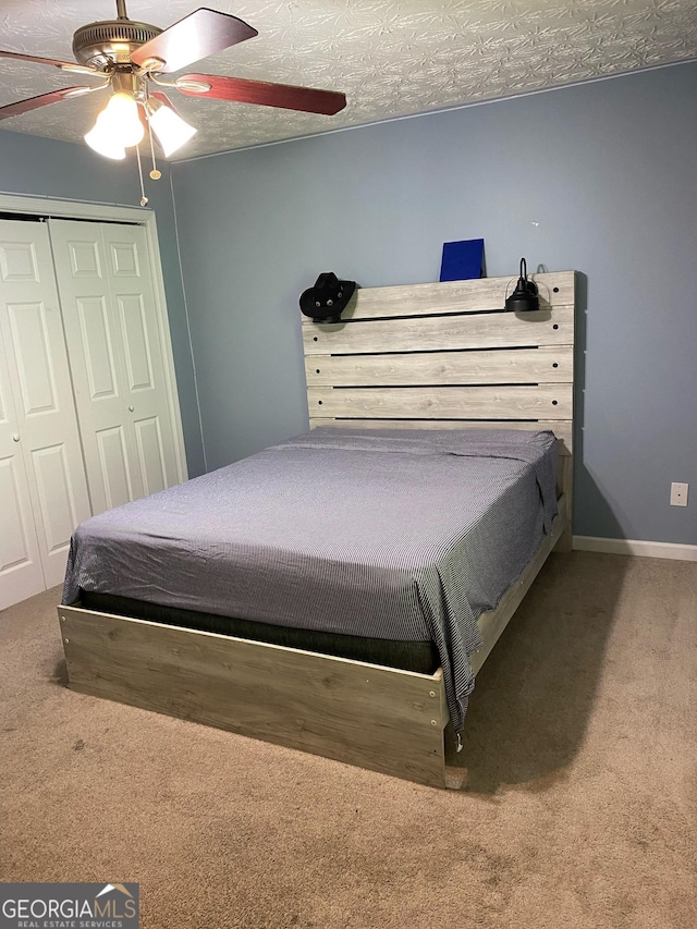 bedroom with carpet, a closet, ceiling fan, and baseboards