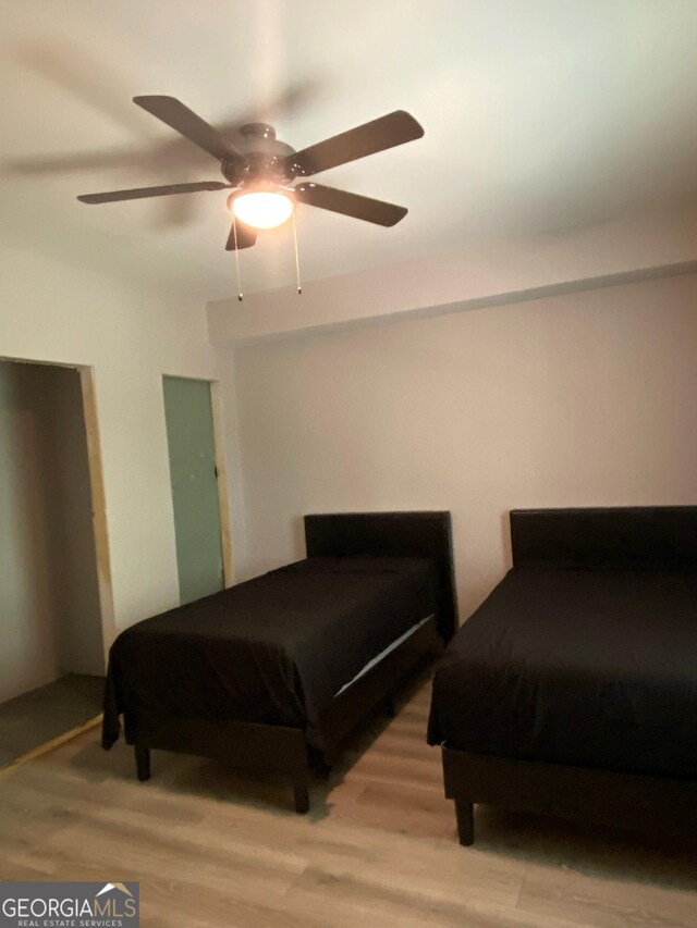 bedroom featuring wood finished floors and a ceiling fan