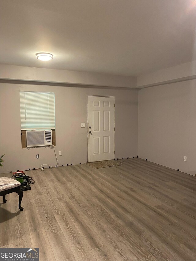 unfurnished living room with light wood-style flooring and cooling unit
