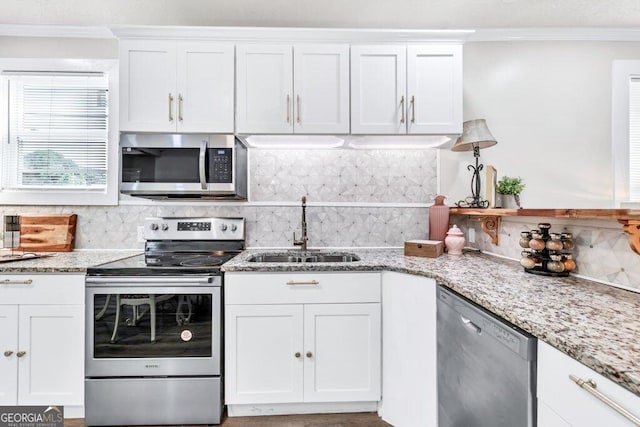 11 Poplar St, Porterdale, GA 30014 - kitchen featuring stainless steel appliances, a sink, decorative backsplash, white cabinetry, and ornamental molding