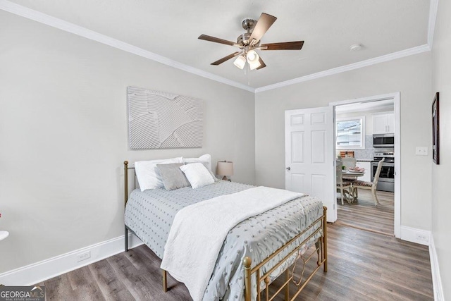 11 Poplar St, Porterdale, GA 30014 - bedroom with wood finished floors, baseboards, ornamental molding, and ceiling fan