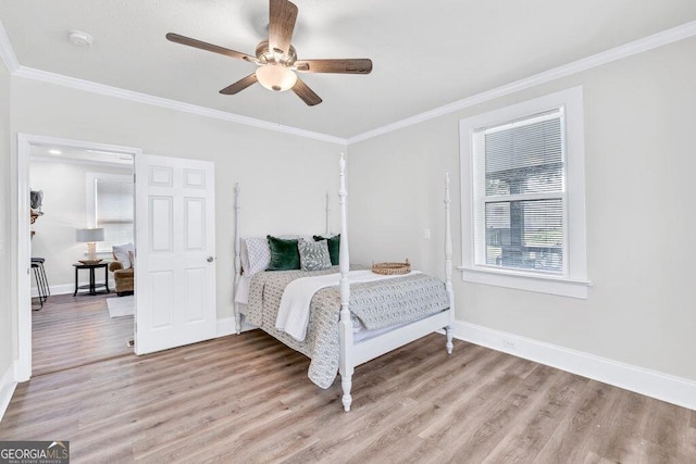 11 Poplar St, Porterdale, GA 30014 - bedroom with light wood finished floors, baseboards, crown molding, and a ceiling fan