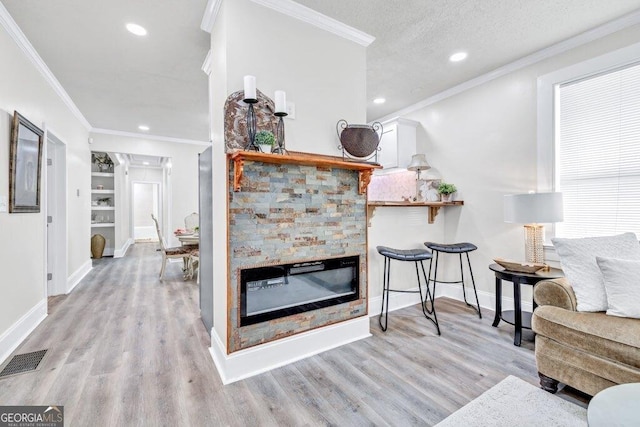 11 Poplar St, Porterdale, GA 30014 - living area with light wood finished floors, ornamental molding, a fireplace, baseboards, and recessed lighting