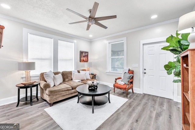 11 Poplar St, Porterdale, GA 30014 - living room with light wood-type flooring, ornamental molding, a ceiling fan, recessed lighting, and baseboards