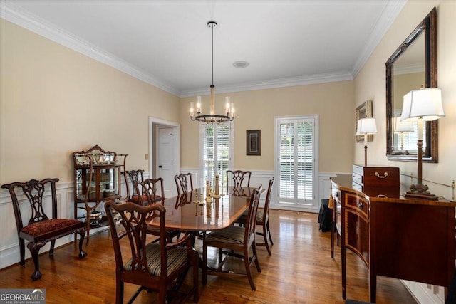 1681 Wild Azalea Ln, Athens, GA 30606 - dining room with a chandelier, crown molding, wood finished floors, wainscoting, and a decorative wall