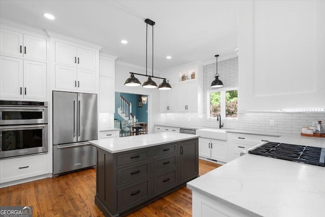 1681 Wild Azalea Ln, Athens, GA 30606 - kitchen with stainless steel appliances, tasteful backsplash, a center island, white cabinetry, and crown molding