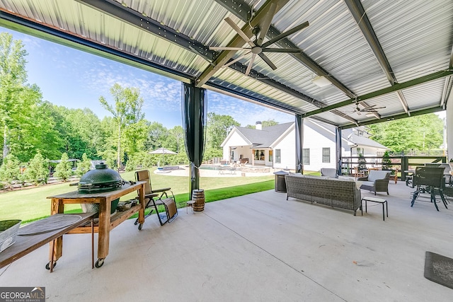 view of patio featuring a ceiling fan, a pool, an outdoor hangout area, outdoor dining area, and view of scattered trees