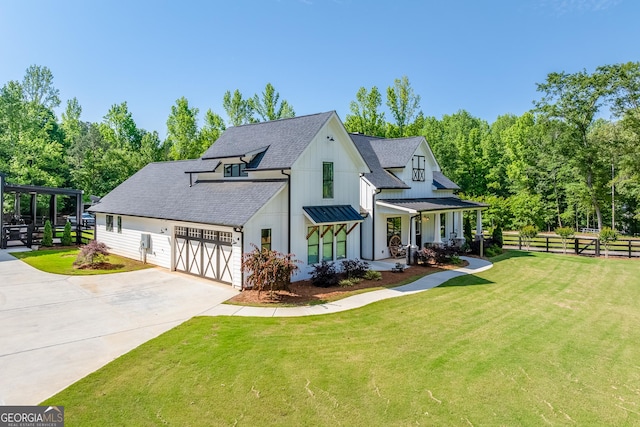 view of front of home featuring a garage, concrete driveway, roof with shingles, covered porch, and board and batten siding