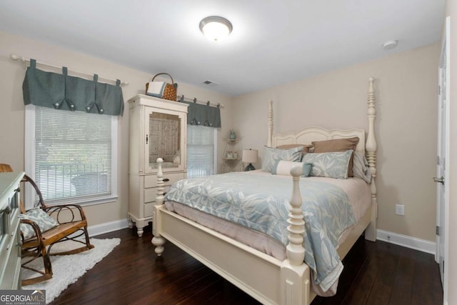 bedroom with hardwood / wood-style floors and baseboards