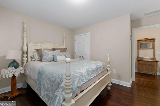 bedroom with wood-type flooring and baseboards