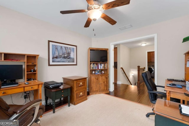 office area with washer / dryer, ceiling fan, and wood finished floors